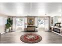 Open-concept living area with modern decor, wood-look floors, and large windows at 2650 W Union Hills Dr # 98, Phoenix, AZ 85027