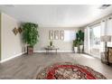 Spacious living room with neutral walls, wood-look floors, and ample natural light at 2650 W Union Hills Dr # 98, Phoenix, AZ 85027