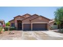 Charming two-story home with a three car garage, desert landscaping, a brown exterior and tile roof at 26633 N 41St Way, Cave Creek, AZ 85331