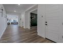Long foyer with hardwood floors and an open floor plan at 28065 N 171St Dr, Surprise, AZ 85387