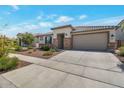 Exterior of single-story home with desert landscaping, stone accents, and a two-car garage at 28065 N 171St Dr, Surprise, AZ 85387