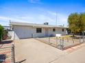 This is a exterior view of the house showing the front yard, driveway, and white exterior at 2834 E Michael Dr, Phoenix, AZ 85032