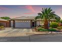 Charming single-story home featuring a two-car garage and desert landscaping at 2910 S Olivewood --, Mesa, AZ 85212