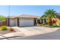 Charming single-story home with a three-car garage and desert landscaping at 2910 S Olivewood --, Mesa, AZ 85212
