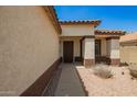 Inviting front entry with well-maintained landscaping and warm color palette, creating a welcoming atmosphere at 3032 W Red Fox Rd, Phoenix, AZ 85083