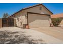 Spacious two-car garage, accessed by a long driveway, provides ample parking and storage space at 3032 W Red Fox Rd, Phoenix, AZ 85083