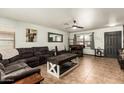 Comfortable living room with tile floors, ceiling fan and bright windows; perfect for entertaining guests at 3032 W Red Fox Rd, Phoenix, AZ 85083