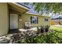 Inviting front porch with seating area, desert plants, and a charming exterior at 308 E La Jolla Dr, Tempe, AZ 85282