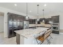 A spacious kitchen is shown with granite countertops, stainless steel appliances, and dark cabinets at 3280 E Coconino Dr, Gilbert, AZ 85298