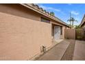 Home exterior featuring neutral color palette, desert landscaping, and private walkway at 3353 E Blackhawk Dr, Phoenix, AZ 85050