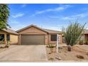 Home exterior featuring desert landscaping, neutral color palette and a two-car garage at 3353 E Blackhawk Dr, Phoenix, AZ 85050