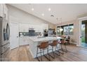 Bright kitchen featuring white cabinets, stainless steel appliances, a large island, and a stylish backsplash at 3604 E Derringer Way, Gilbert, AZ 85297