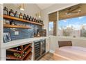 Chic wet bar area with wine storage, custom shelving, and elegant countertops, ideal for entertaining guests at 3604 E Derringer Way, Gilbert, AZ 85297