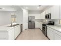 Modern kitchen featuring stainless steel appliances, including a range, microwave, and refrigerator at 3815 S 64Th Ln, Phoenix, AZ 85043