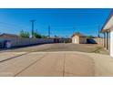 Large backyard with a shed and mature trees, perfect for outdoor activities at 3944 W Wilshire Dr, Phoenix, AZ 85009