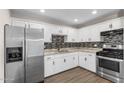 Well-equipped kitchen with stainless steel appliances and white cabinetry at 3944 W Wilshire Dr, Phoenix, AZ 85009