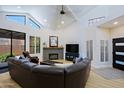 Bright living room featuring vaulted ceilings, clerestory windows and a comfortable leather wraparound sofa at 4039 E Paradise Dr, Phoenix, AZ 85028