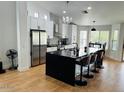 Modern kitchen featuring a large island with seating, sleek countertops, and stainless steel appliances at 4102 E Rancho Tierra Dr, Cave Creek, AZ 85331