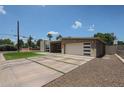Beautiful modern home showcasing clean lines, an attractive driveway, and drought-resistant landscaping at 4202 E Catalina Dr, Phoenix, AZ 85018