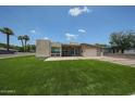 Well-maintained home featuring stylish architecture, green lawn, and desert-friendly landscaping details at 4202 E Catalina Dr, Phoenix, AZ 85018