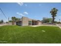 Contemporary desert home with a well-manicured lawn, mature trees, and sleek architectural design at 4202 E Catalina Dr, Phoenix, AZ 85018