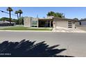 Charming single-story home boasting a modern facade, manicured lawn, and an attached garage with a unique door design at 4202 E Catalina Dr, Phoenix, AZ 85018