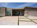 Modern home featuring a walkway with grass accents, a large front window, and desert landscaping at 4202 E Catalina Dr, Phoenix, AZ 85018