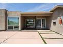 Modern home featuring a walkway with grass accents, a large front window, and desert landscaping at 4202 E Catalina Dr, Phoenix, AZ 85018