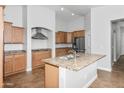 Bright kitchen with stainless steel appliances, a center island, and wood cabinets at 4455 E Marshall Ave, Gilbert, AZ 85297