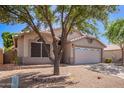 Charming single-story home with well-maintained desert landscaping, a two-car garage, and a walkway at 4911 E Holmes Ave, Mesa, AZ 85206