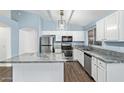 Modern kitchen with white cabinets, stainless steel appliances, granite counters, and a center kitchen island at 4911 E Holmes Ave, Mesa, AZ 85206