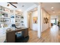 Well-lit home office with custom built-ins provides a perfect space for work and productivity at 5515 S Caisson Way, Mesa, AZ 85212