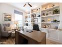 Spacious home office with custom built-ins, perfect for focusing on all of your business needs at 5515 S Caisson Way, Mesa, AZ 85212