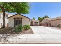 Well maintained home with desert landscaping and a long driveway leading to a two car garage at 6805 S Sapphire Way, Chandler, AZ 85249