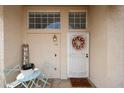 Welcoming entryway featuring a decorative wreath, seating area, and 'Hello' door mat at 7110 N 28Th Dr, Phoenix, AZ 85051