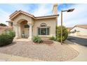 Well-maintained home featuring a tile roof, stucco exterior, and landscaped yard with vibrant yellow flowers at 7110 N 28Th Dr, Phoenix, AZ 85051