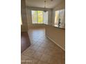 Bright dining area featuring tile flooring, breakfast bar, and large windows offering ample natural light at 8008 W Ross Ave, Peoria, AZ 85382