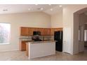 Well-lit kitchen boasts ample cabinet space, granite countertops, modern appliances, and tiled floors at 8008 W Ross Ave, Peoria, AZ 85382