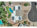 Aerial shot of home featuring a pool, solar panels, desert landscaping, and a tile roof at 8936 N 80Th Pl, Scottsdale, AZ 85258