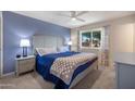 Serene main bedroom with carpet floors, stylish nightstands, and a window showcasing outdoor scenery at 9051 E Grandview Dr, Mesa, AZ 85207