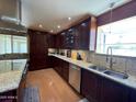 Well-appointed kitchen with wood cabinetry, stainless steel appliances, and granite countertops at 9221 N 48Th Dr, Glendale, AZ 85302