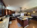 Spacious kitchen with stainless steel appliances, granite countertops, and a center island at 9221 N 48Th Dr, Glendale, AZ 85302