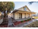 Inviting single-story home with a covered porch, established plants, and mature trees at 937 E 6Th Ave, Mesa, AZ 85204