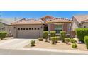 Single story house with a well-kept front yard, two-car garage, and a tile roof at 9535 E Tupelo Ave, Mesa, AZ 85212