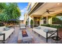 Relaxing back patio with cozy seating and a stylish fire pit, perfect for outdoor living at 970 W Zion Way, Chandler, AZ 85248