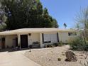 Charming single-story home with desert landscaping, dark shutters, and a covered front porch at 1022 E Keim Dr, Phoenix, AZ 85014