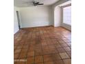 Neutral living room with tile flooring, ceiling fan, and natural light from a window at 1022 E Keim Dr, Phoenix, AZ 85014