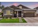Charming single-story home with well-manicured lawn, brick accents, and a two-car garage at 1026 N 152Nd Ave, Goodyear, AZ 85338