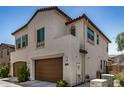 Two-story home with brown garage doors, stucco exterior, and decorative window accents at 1153 W Diamondback Dr, Chandler, AZ 85286