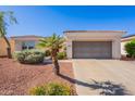 Charming home featuring a two-car garage and low-maintenance desert landscaping at 12910 W Junipero Dr, Sun City West, AZ 85375